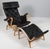 Bruno Mathsson Pernilla lounge chair with ottoman, original upholstery in black leather. Frame in lacquered beech. Made by...