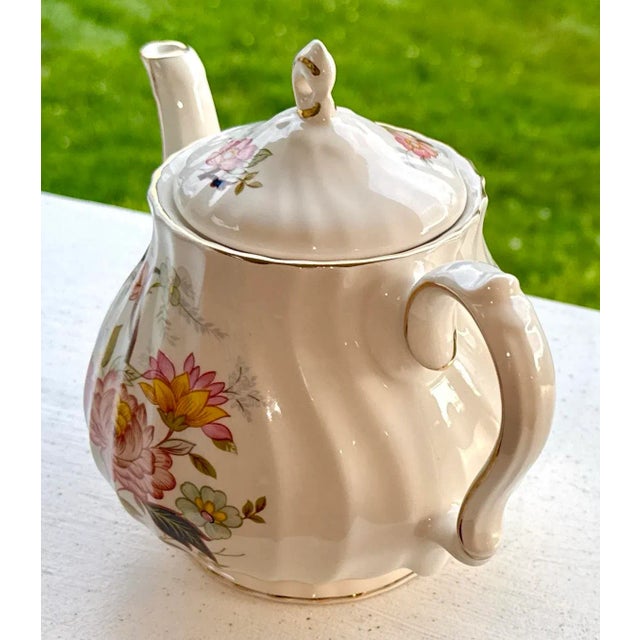 Vintage Sadler Ivory Tea Pot, with a floral chintz design and gold finish. The tea pot has a swirl design. Manufacturer:...