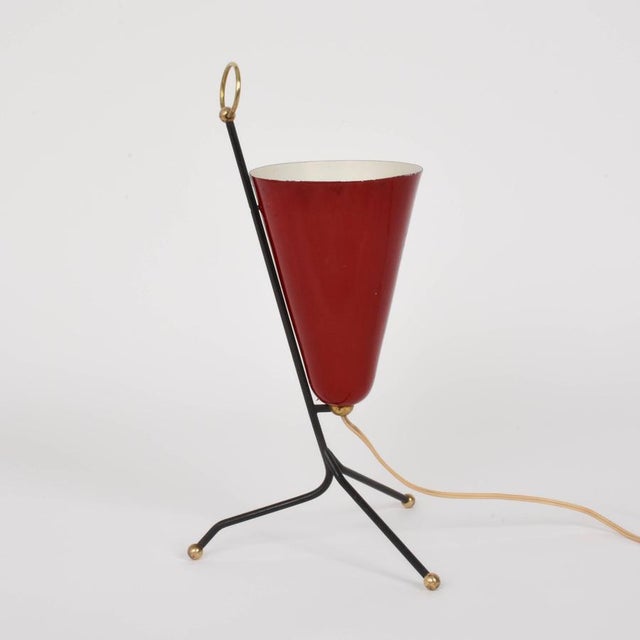 Amazing table lamp in lacquered metal and brass with tripod base. This fantastic piece was designed in Italy during the...