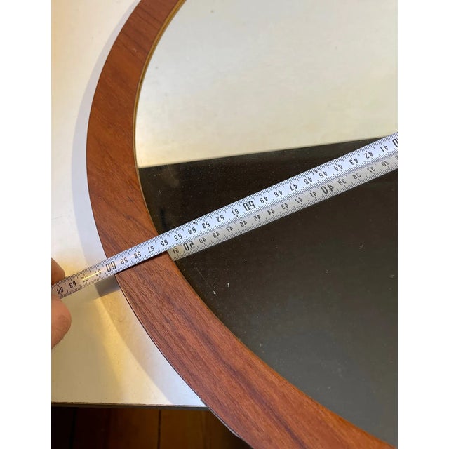 A large (60 cm) circular wall-mounted mirror in teak. Probably made by either Sika Moebler or Petersen Spejle in Denmark...