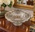 Elegant vintage clear pressed glass centerpiece bowl featuring an elaborate silver overlay decoration and a silver-trimmed...