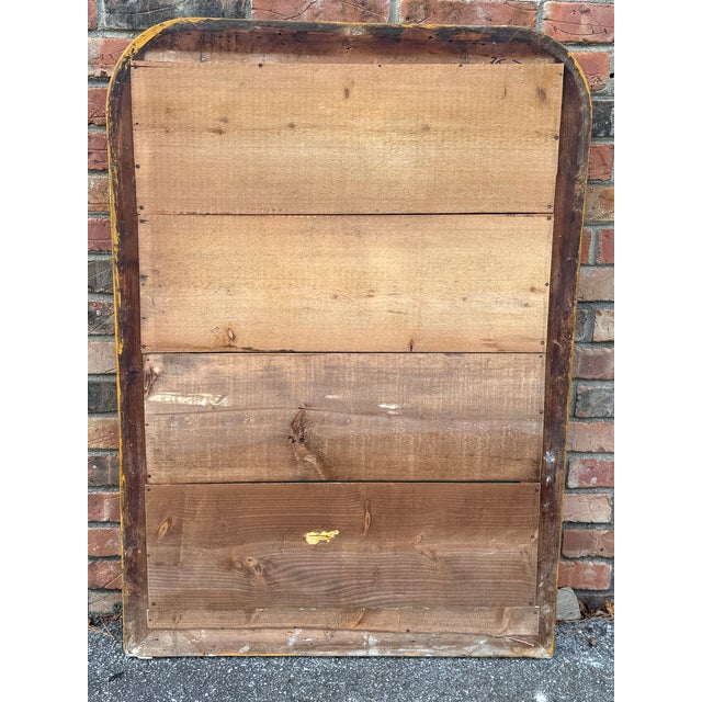 This gorgeous Louis Philipe mirror has a beautiful gold leaf frame with rich red undertones. This large size would be...