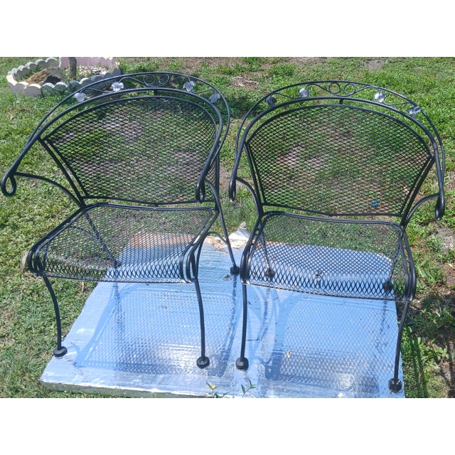 This pair of black wrought iron chairs iare vintage Russell Woodard mesh barrel back armchair from around 1950. Features a...