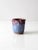 A vintage studio pottery vase, hand-crafted with a luminous blue glaze accented by a dramatic purple-pink drip along the...