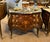 Make a statement with this magnificent French bombe commode, showcasing exceptional floral marquetry, graceful serpentine...