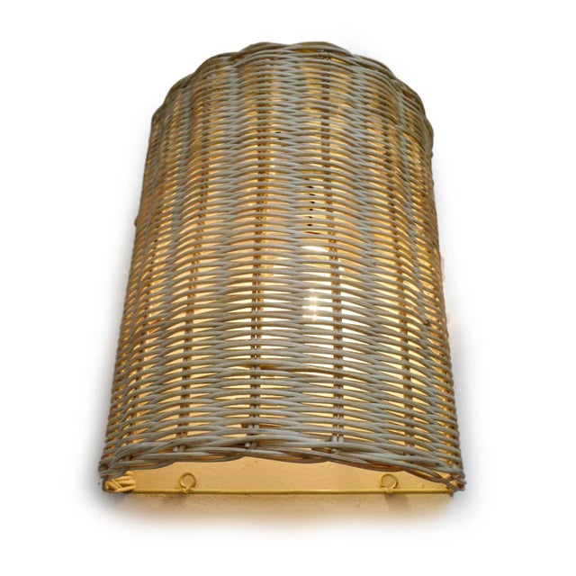Modern raw woven wicker sconce cover. Beautiful warm glow with clean lines. Can be used to hang over an existing wall...