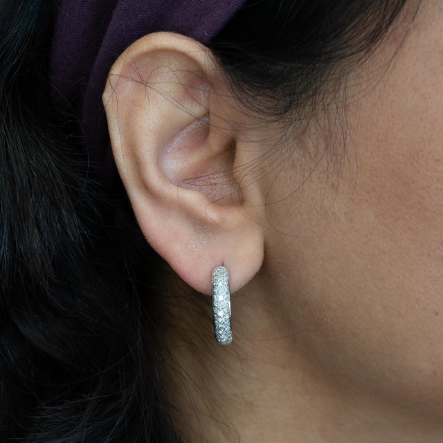 Timeless and effortlessly chic, these 1Ct diamond huggie earrings are crafted in solid 14K gold for everyday elegance....