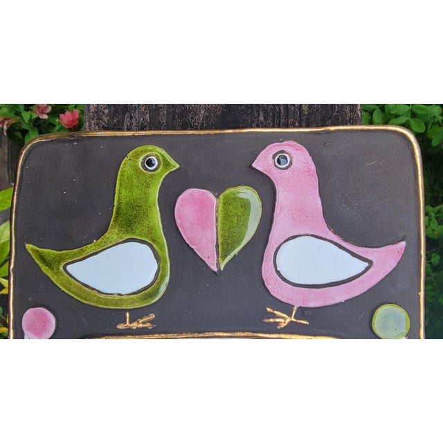 Glazed polychrome ceramic wall mirror by renowned French artist Mithé Espelt. Green and pink doves or lovebirds with...