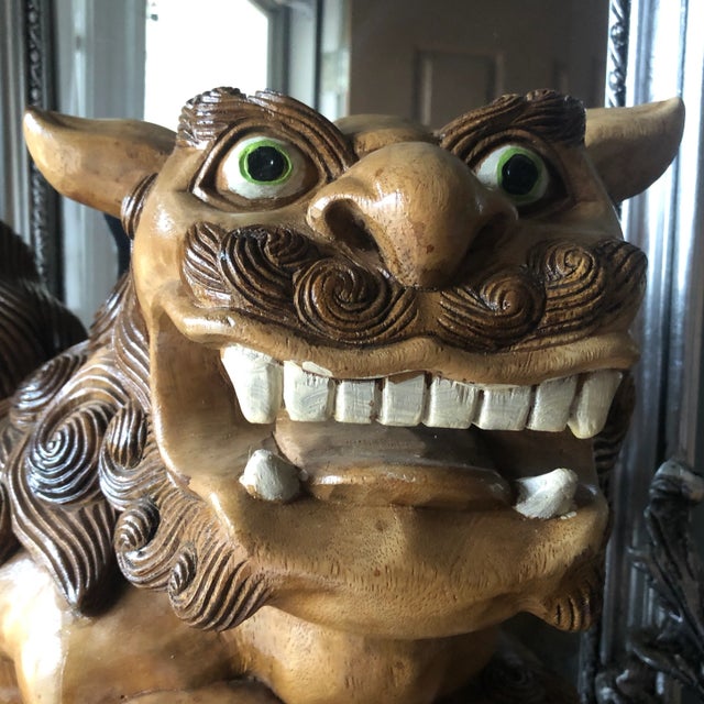 Beautiful pair of wooden hand carved dogs. Foo dogs are actually lions. They originated in China, shi, meaning lion or...