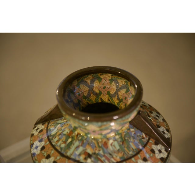 A Vallauris ceramic vase with a generous body and slightly flared neck. The highly graphic polychrome decoration...