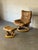 This Stressless recliner and matching ottoman feature an ergonomic high-back design with smooth swivel function. A curved...
