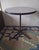 Charles and Ray Eames contract base bistro table with a light purple-grey or taupe circular top. The style of the label...