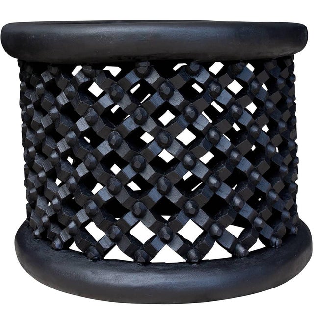 This striking Black Bamileke coffee table is a sculptural statement piece, handcrafted by skilled artisans in Cameroon....