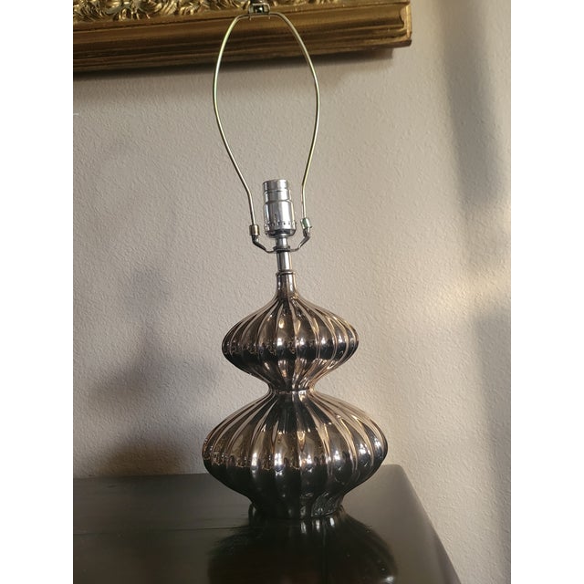 Vintage mid‑century modern ribbed chrome table lamp, featuring a reflective silver body with vertical fluting and a...