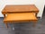 Beautiful vintage wooden writing desk featuring a warm honey-toned finish, two front drawers, and elegant turned legs. A...