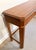 This classic console table for Drexel Heritage features a warm fruitwood finish, classic fluted pillar legs, and a subtle...