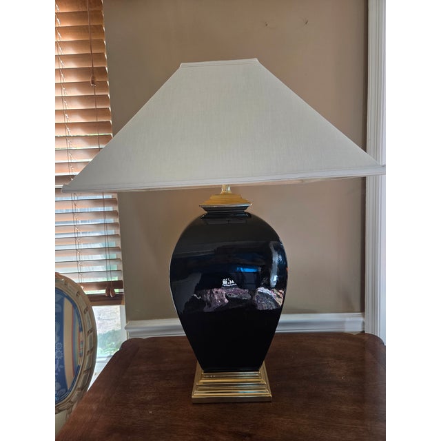 Stunning Vintage Black Porcelain and Brass Table Lamp. Striking the perfect balance between dramatic Hollywood Regency and...