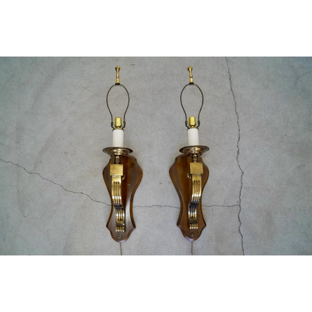 Vintage 1970's sconces for sale. They're in incredible original condition, and well made. They have a solid wood plate...