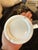A vintage Gucci ceramic ashtray crafted in Italy, featuring a clean, minimalist design in glossy white ceramic accented by...