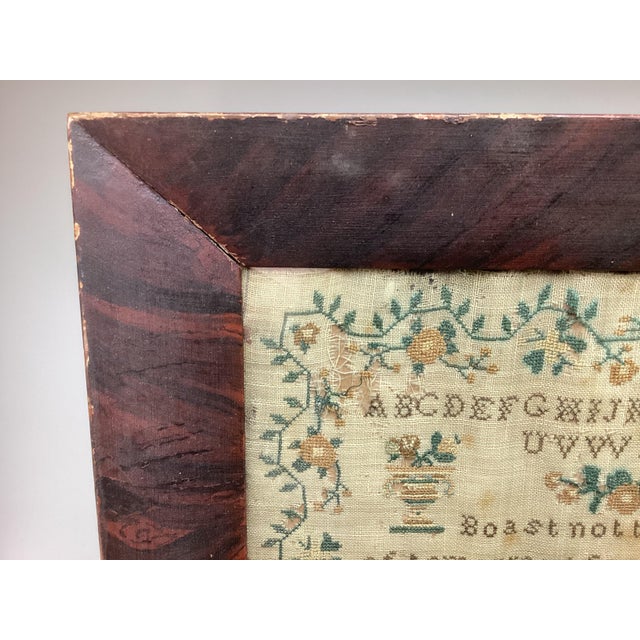 This is a 19th-century needlework sampler dated 1839 and signed by Susanna Rolfe. The piece features alphabet rows, a...