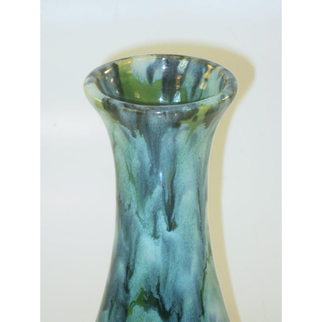 This Mid Century Modern vase features a blue and green drip glaze ceramic and porcelain base with an Art Moderne style. It...