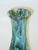 This Mid Century Modern vase features a blue and green drip glaze ceramic and porcelain base with an Art Moderne style. It...
