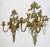 Pair of vintage Hollywood Regency style brass sconces depicting love birds on floral branch. Ribbon topper with intricate...