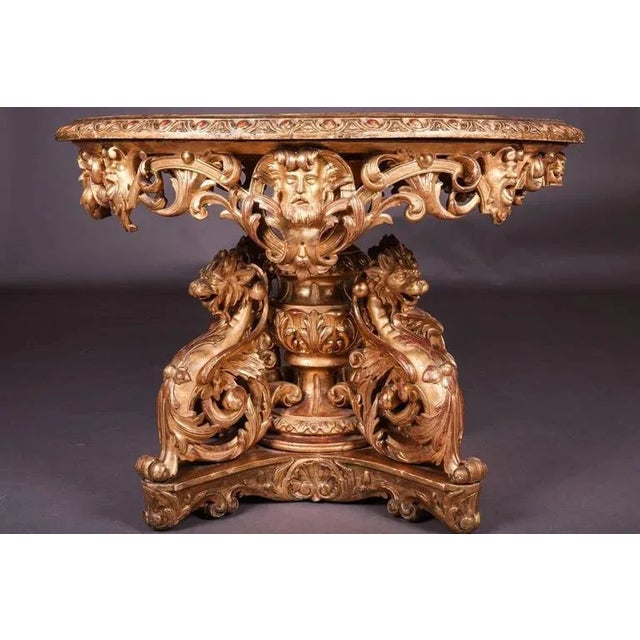 Solid wood carved and poliment sheet-gilded. Figurine carving in the form of chimera and satyr masks. Probably from a...