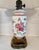 Elegant Chinoiserie-style porcelain lamp featuring colorful floral decoration with red and gilt accents. Set on an ornate...