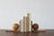 A pair of wooden bookends with a geometric, sculptural form, embodying the aesthetic of postwar modernism. Each piece is...