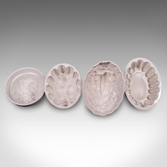 This is a set of 4 antique jelly moulds. An English, ceramic decorative mould with pattern finishes, dating to the late...