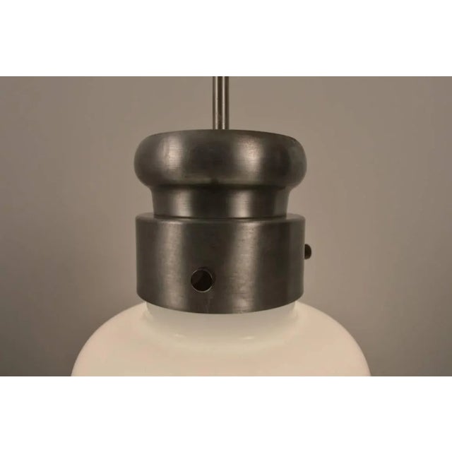 Modernist Globe hangs from steel stem, attributed to Nessen Studios.