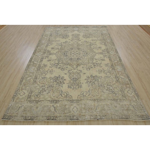 An authentic vintage traditional Tabriz rug hand-knotted with an all-wool pile on a cotton foundation. This oriental rug...