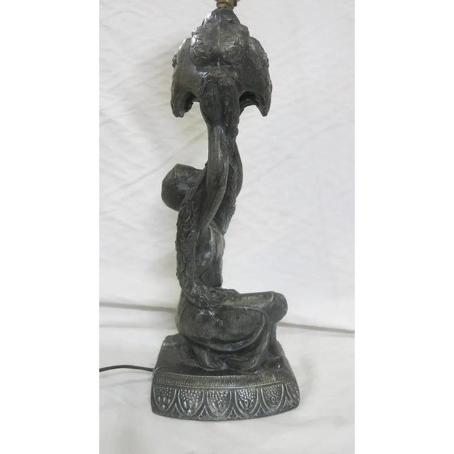 Art Deco table lamp. Bronze style Spelter Joan of Arc holding up a bouquet, kneeling on a pedestal by La Belle....