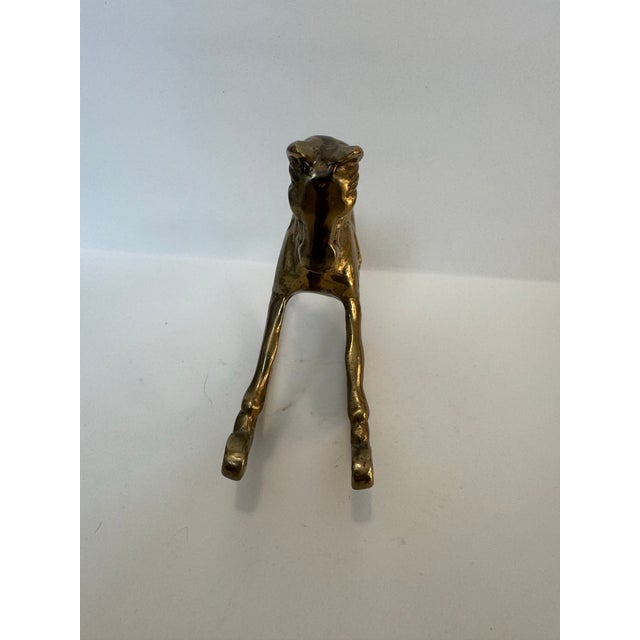 This charming solid brass rocking horse is a quintessential piece of Mid-Century nursery or shelf decor. Boasting a rich,...