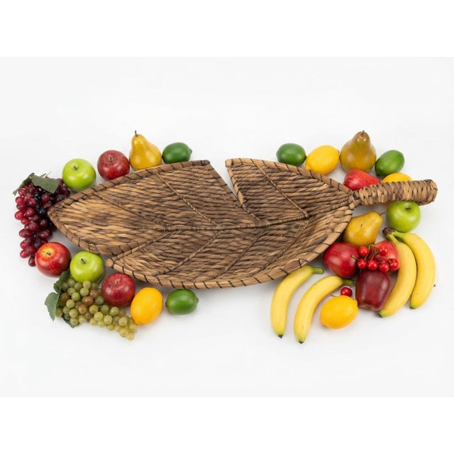 A charming oversized woven harvest basket filled with an abundant assortment of beautifully realistic decorative fruit....