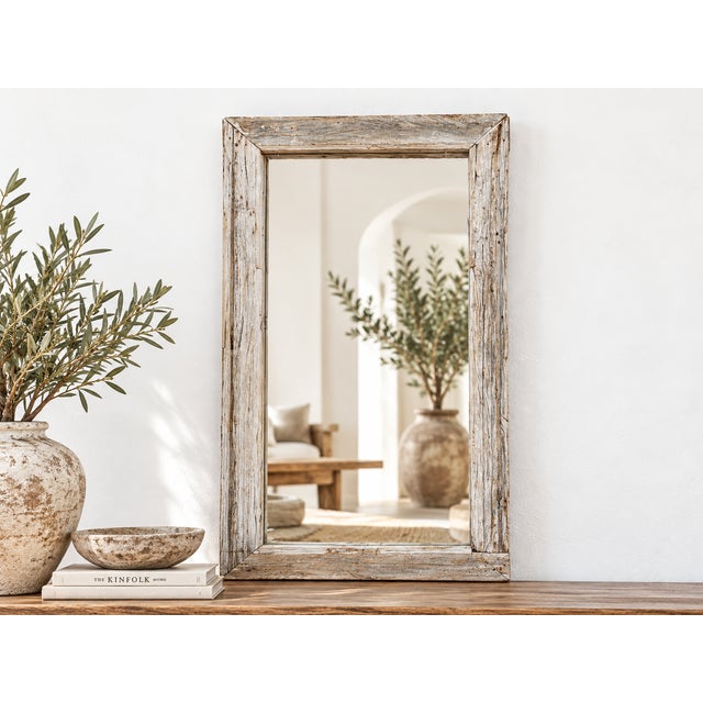 There is a quiet poetry in repurposing the past. This mirror was once a functional antique window frame, perhaps looking...