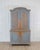 A beautiful early 19th century Rococo cabinet featuring elegant reeded top doors and a softly repainted finish in muted...