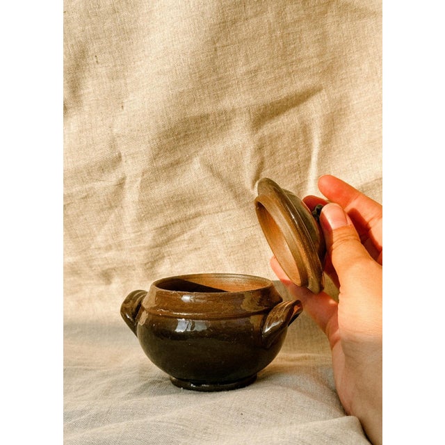 Small in size but full of character. This dark stoneware French tureen is a time capsule, with its glossy glaze and round...