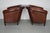 This pair of cognac-colored leather club chairs come from the Netherlands. They are upholstered with patinated cognac-...