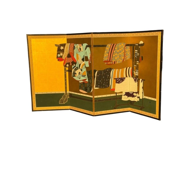 Four panel folding screen with gilt background and colored pigment on rice paper. With image depicting garment racks and...