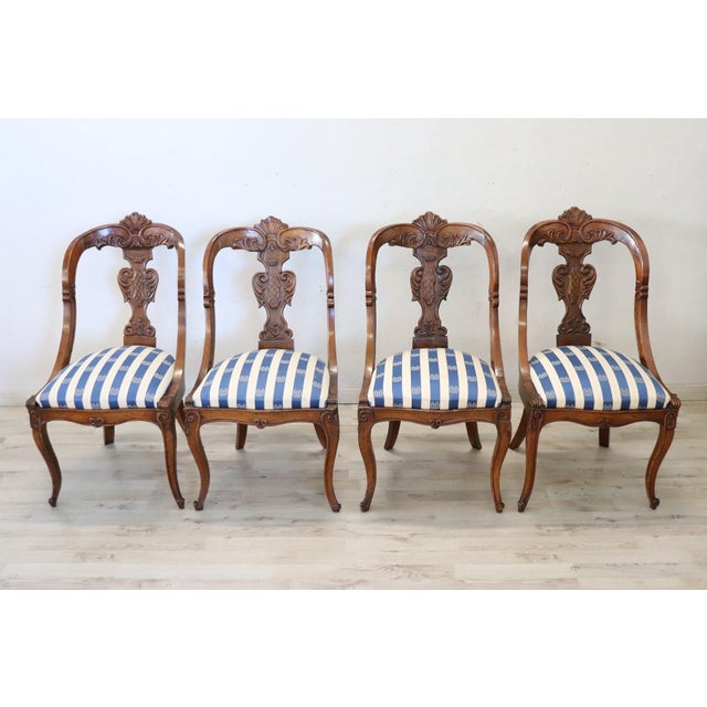 Beautiful 19th century of the period Charles X Italian set of four chairs antique in solid walnut wood. Characterized by...