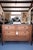 A refined 19th-century French Louis XVI–style commode topped with a richly veined black marble slab. Crafted in warm-toned...