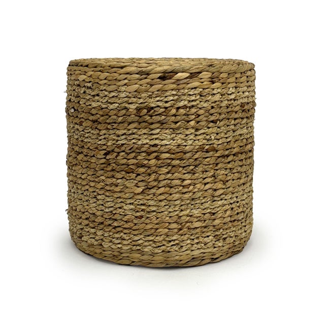 The Woven Ottoman from Zentique is a handwoven cylinder ottoman in light brown water hyacinth and corn husk leaf with a...