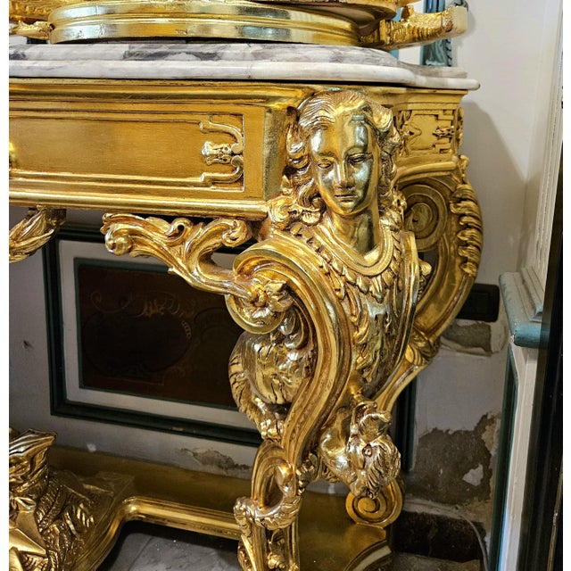 Make a dramatic statement with this grand French-style console table, featuring an impressive marble top and an...