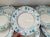A dozen large Minton porcelain dinner plates decorated in a flower and vine pattern in light blue aqua and light mauve...