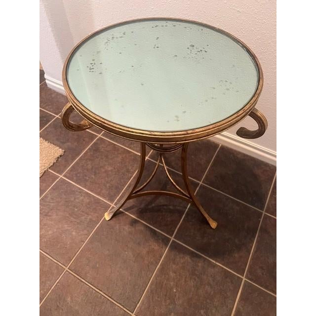 The elegant Neoclassical style gueridon side table features a distinctive circular silhouette with flared, decorative...