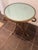 The elegant Neoclassical style gueridon side table features a distinctive circular silhouette with flared, decorative...