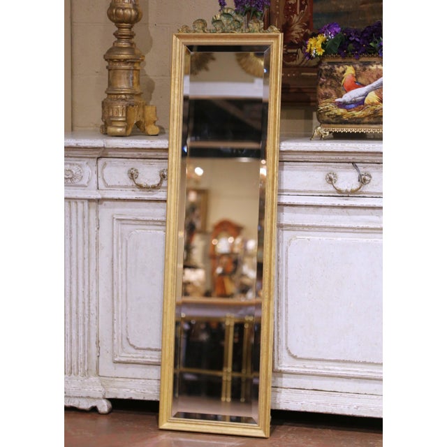 Crafted in the French taste circa 1980, this tall giltwood mirror reflects the refined elegance of Louis XVI design....