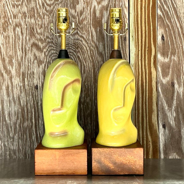A striking pair of vintage Mid-Century Modern Heifetz lamps, crafted from glazed ceramic with sculptural silhouettes....